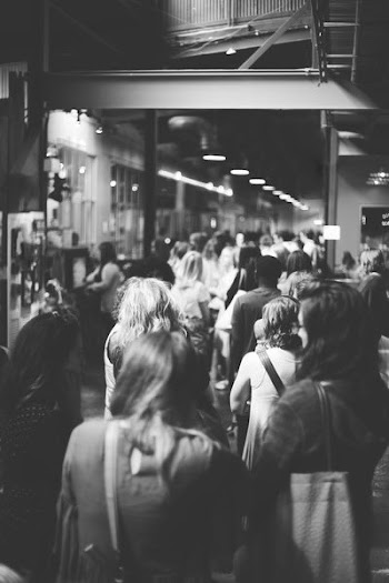 grayscale photo of crowd inside building