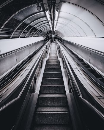 grayscale photo of escalator