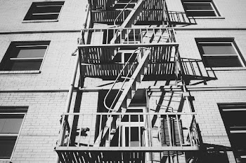 Grayscale Photo of Escape Stairs