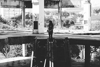 Grayscale Photo of Girl Standing on Concrete Pavement