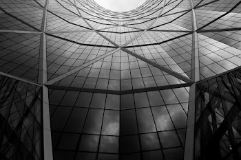 grayscale photo of grey glass wall