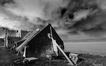 Grayscale Photo of House Under Cloudy Sky