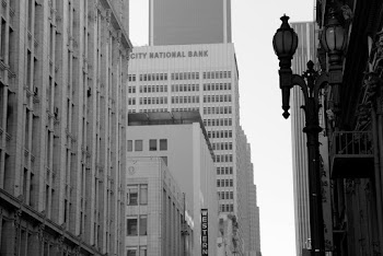 Grayscale Photo of Lamp Post and Buildings