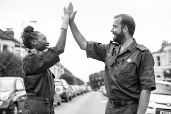 Grayscale Photo of Man and Woman Doing High-five