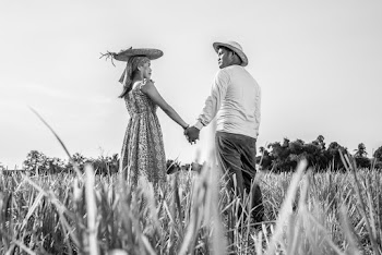 Grayscale Photo of Man and Woman Holding Hands Outdoors