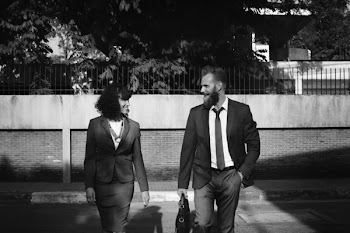 Grayscale Photo of Man and Woman in Formal Suits