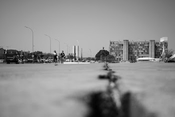 Grayscale Photo of Man and Woman Walking On The Sidewalk