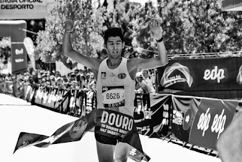 Grayscale Photo of Man at the finish line of a marathon race