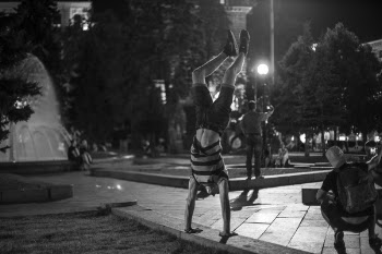 Grayscale Photo of Man Doing Hand Stand on Park