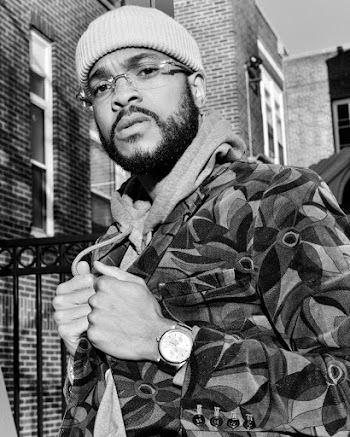 Grayscale Photo of Man Holding His Jacket