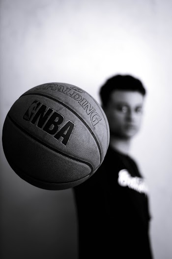 Grayscale Photo of Man Holding Nba Basketball