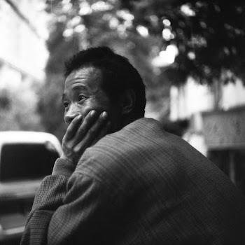 Grayscale Photo Of Man in Black and White Pinstripe Jacket