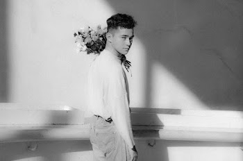 Grayscale Photo of Man In Long-sleeved Shirt Carrying A Bouquet Of Roses