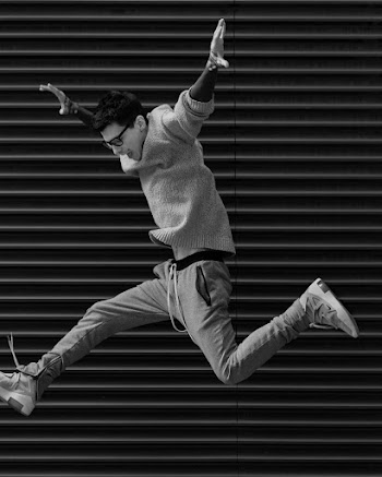Grayscale Photo Of Man Jumping