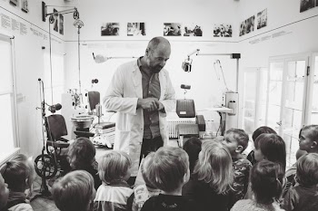 Grayscale Photo of Man Lecturing Children