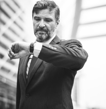 Grayscale Photo of Man Looking at His Watch