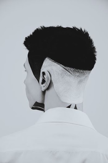 grayscale photo of man looking back