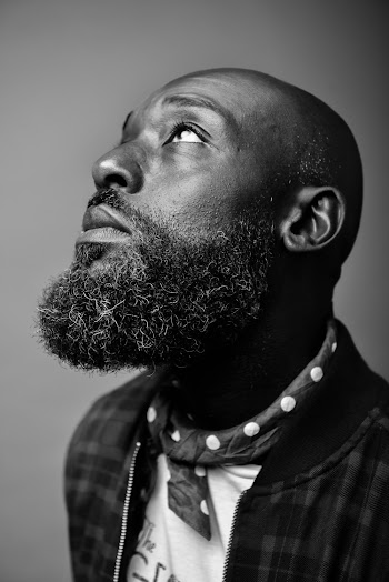 Grayscale Photo of Man Looking Up