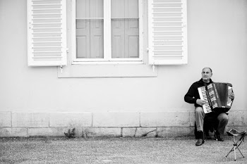grayscale photo of man playing accordion