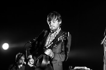 Grayscale Photo of Man Playing Guitar