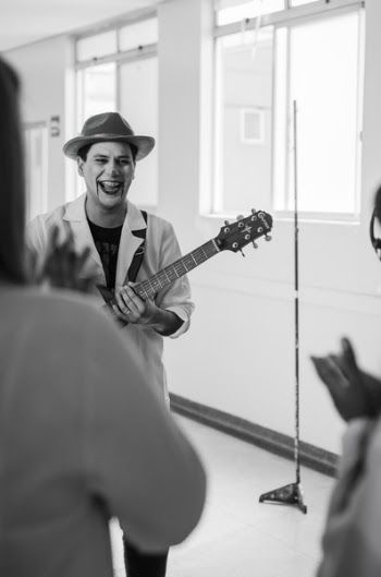 Grayscale Photo of Man Playing Guitar