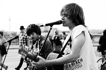 Grayscale Photo of Man Playing Singing and Playing Guitar