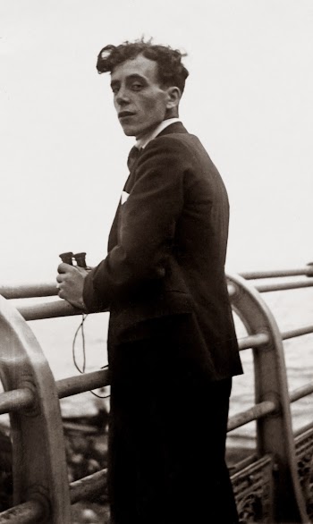 Grayscale Photo of Man Standing by the Railings
