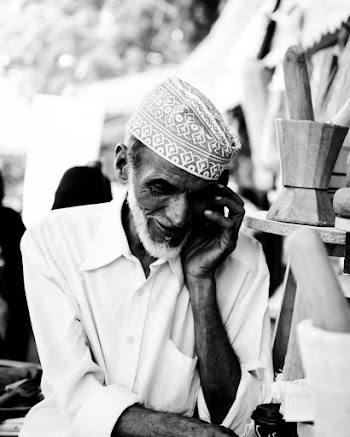 Grayscale Photo of Man Taking Call