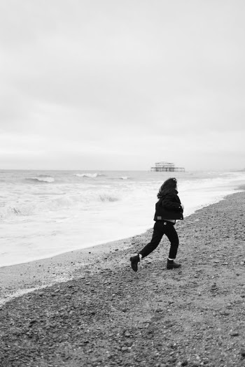Grayscale Photo of Man Walking on Beach · Free Stock Photo