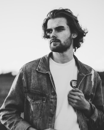 Grayscale Photo of Man Wearing Denim Jacket