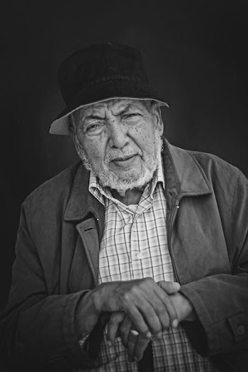 grayscale photo of man wearing jacket