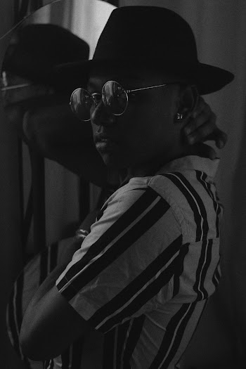 Grayscale Photo of Man Wearing Striped Shirt and Fedora Hat