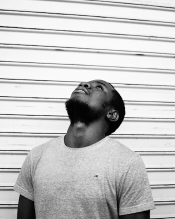 Grayscale Photo of Man Wearing Tommy Hilfiger Shirt