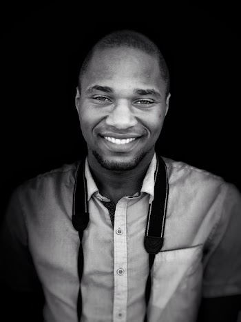 Grayscale Photo of Man With Camera Sling on Neck