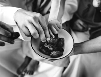 Grayscale Photo of People Eating on Bowl