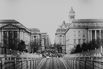 grayscale photo of people in city