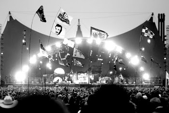 grayscale photo of people near stage