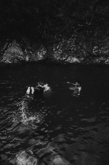 Grayscale Photo of People Swimming