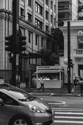 Grayscale Photo of People Walking on Sidewalk · Free Stock Photo