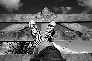 Grayscale Photo of Person's Shoes