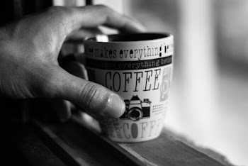 Grayscale Photo of Person Hand Holding Ceramic Cup