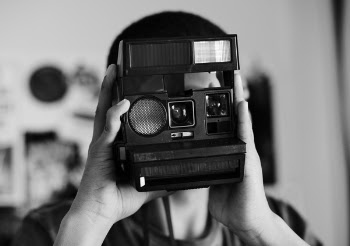 Grayscale Photo of Person Holding a Camera