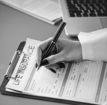 Grayscale Photo of Person Holding Pen