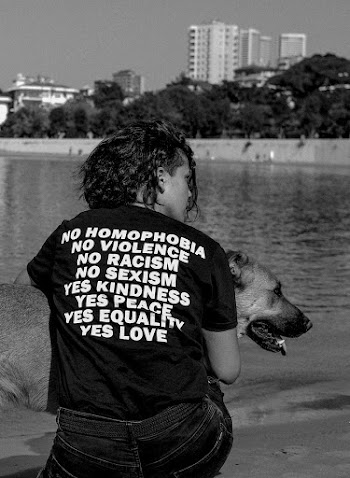 Grayscale Photo of Person Hugging Dog
