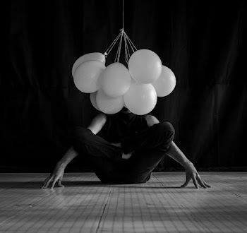 Grayscale Photo of Person in Front of Balloons