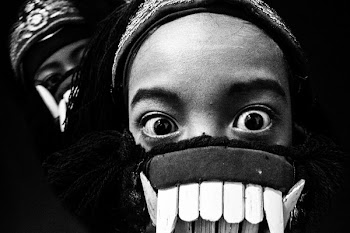 Grayscale Photo of Person in Mask Taking Selfie