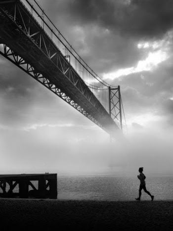 Grayscale Photo of Person Jogging Near River
