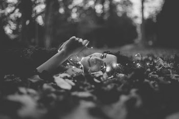 Grayscale Photo of Person Lying on Ground