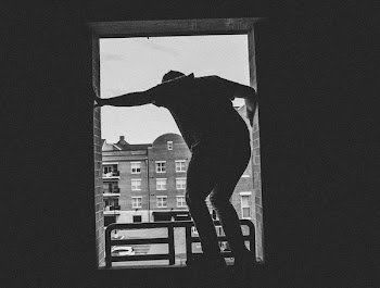 Grayscale Photo of Person Near Building