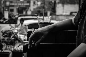 Grayscale Photo of Person Resting His Arm